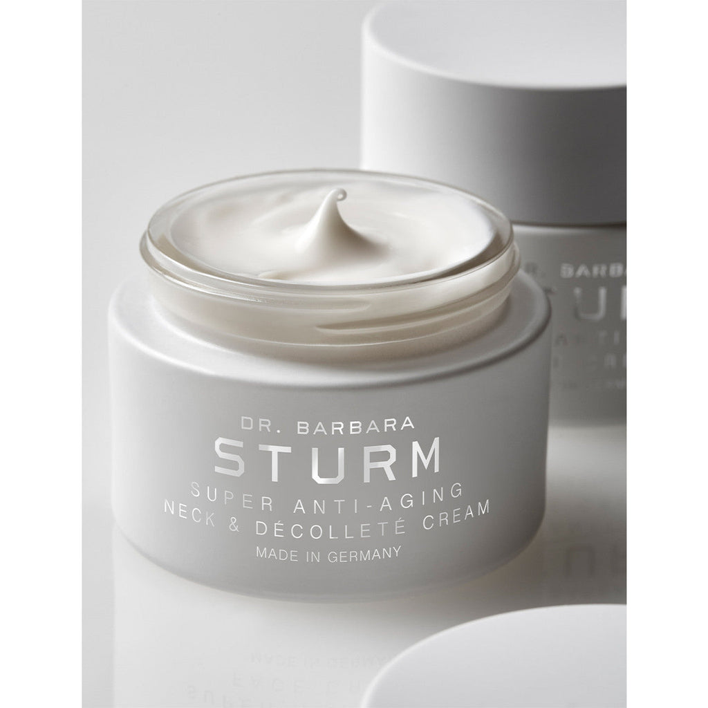 Jar of dr. barbara sturm anti-aging neck and decollete cream with product visible on top.