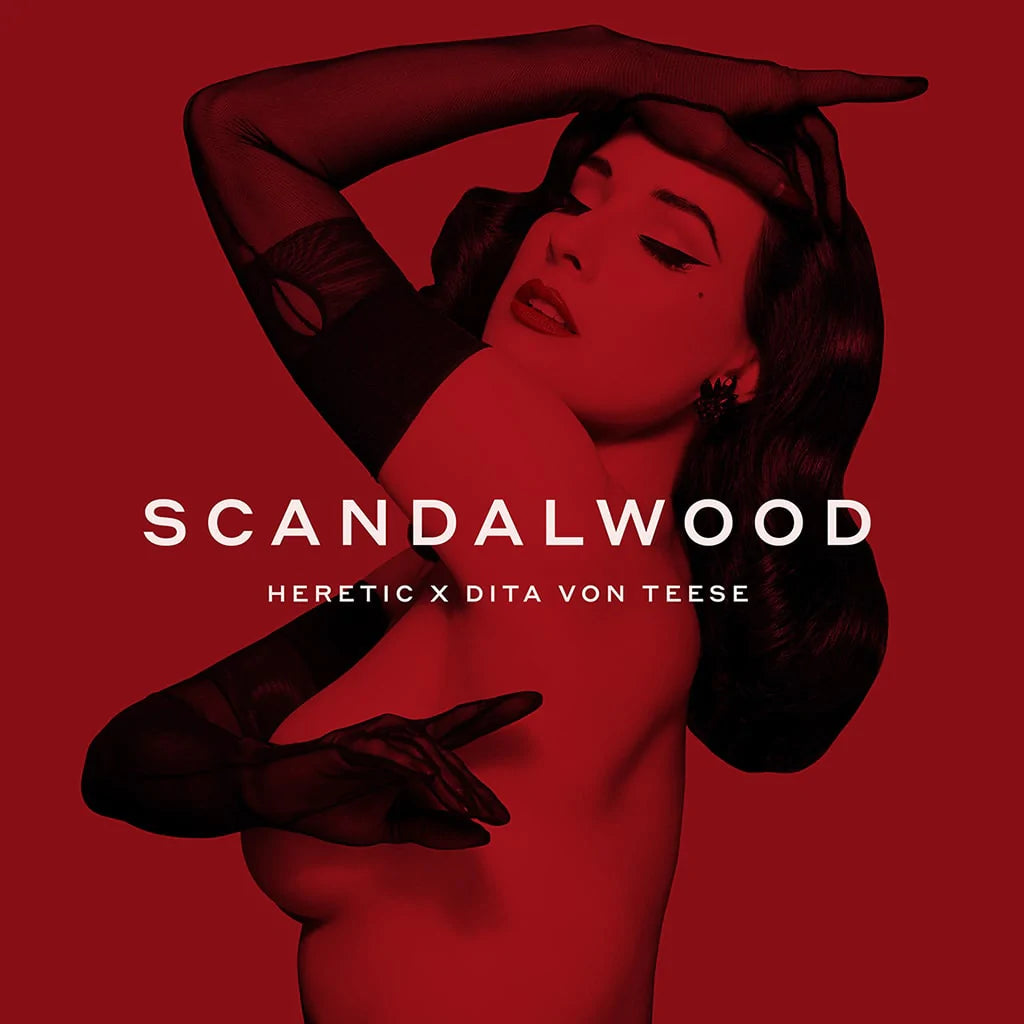 A stylized promotional image featuring dita von teese in a red monochrome setting for the fragrance scandalwood by heretic.