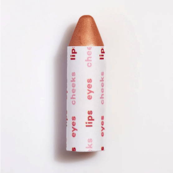 A cone-shaped cosmetic product with "lips cheeks eyes" text printed on its packaging.