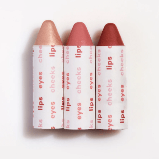 Three lipstick sticks on a white background.