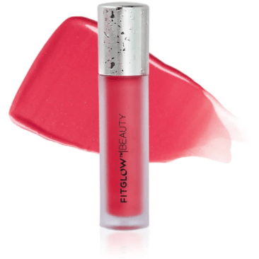 A tube of fitglow beauty lip gloss with a red smear of the product behind it.