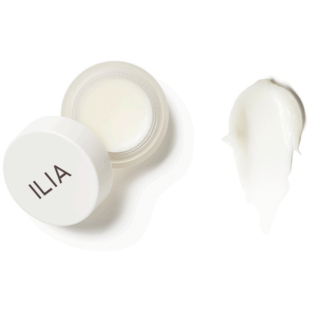 Open jar of ilia beauty product with a swatch of cream beside it.