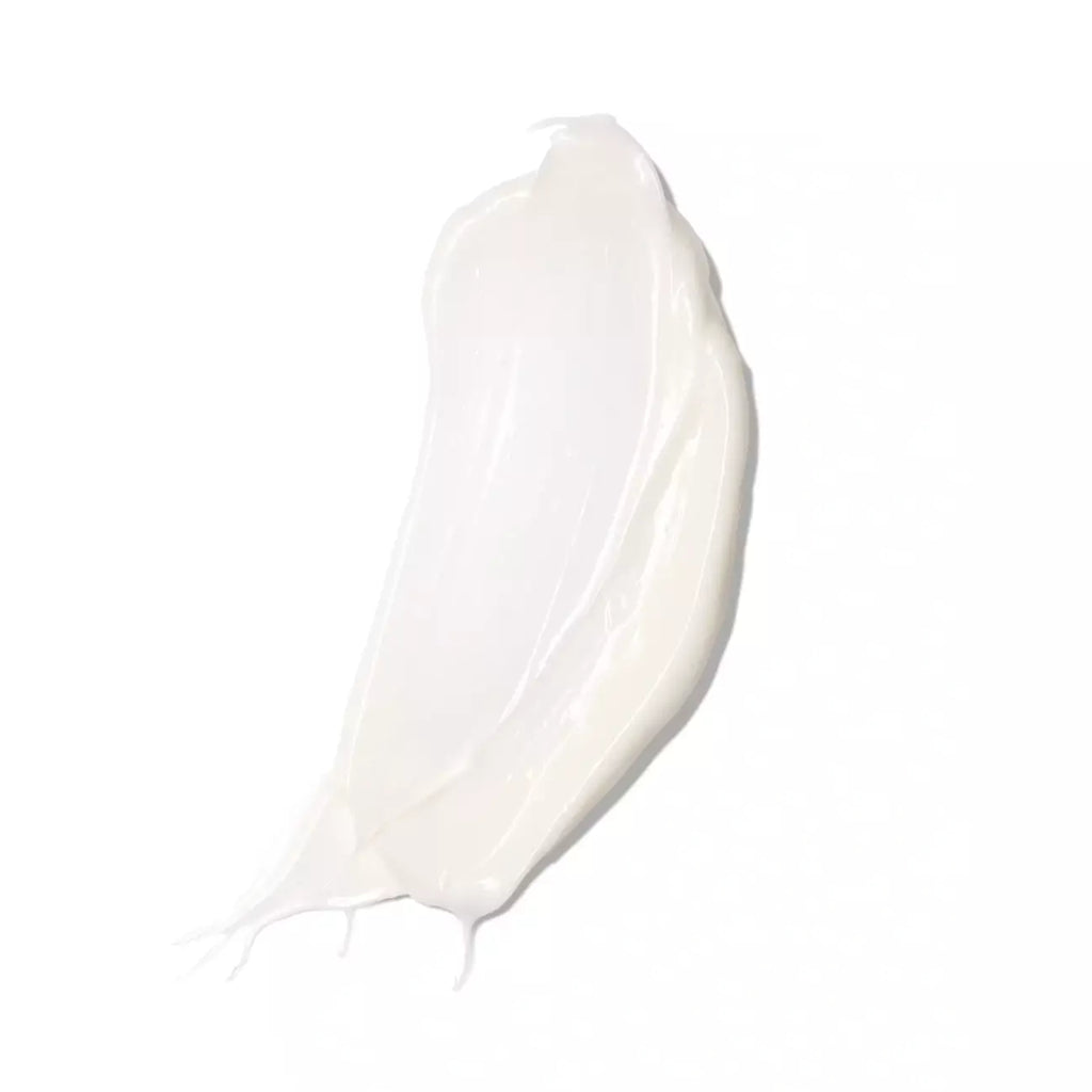 A smear of white cream on a plain background.