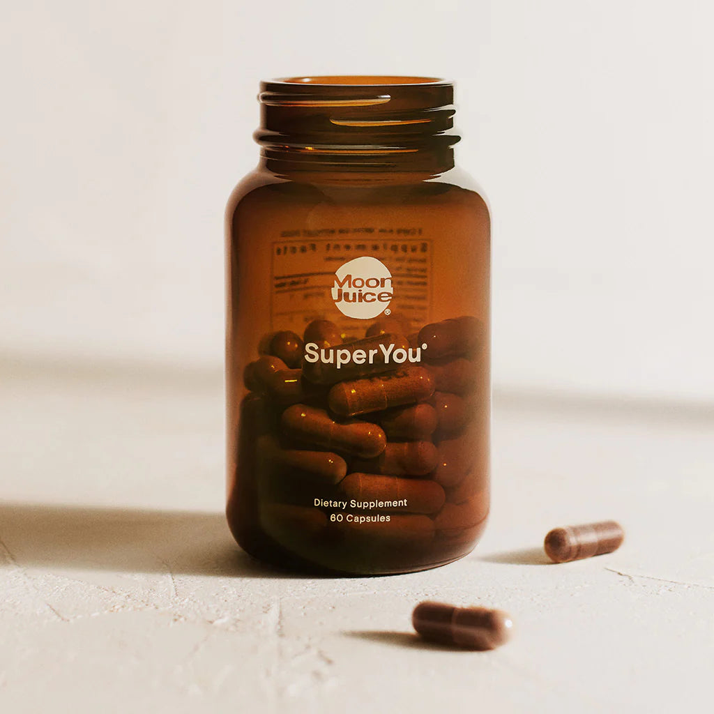 A bottle of super-you on a white surface.