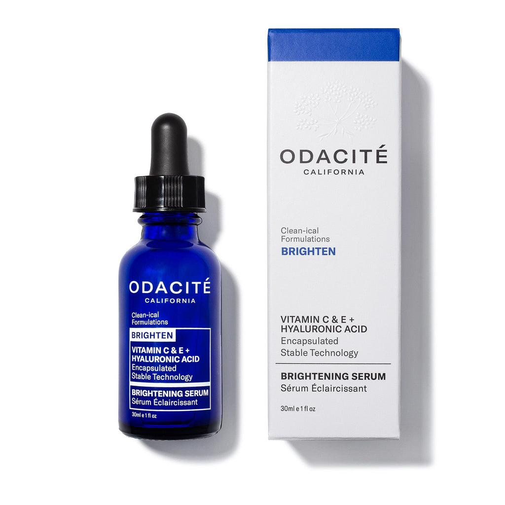 A bottle of odacite brightening serum and its packaging, featuring vitamin c and e.