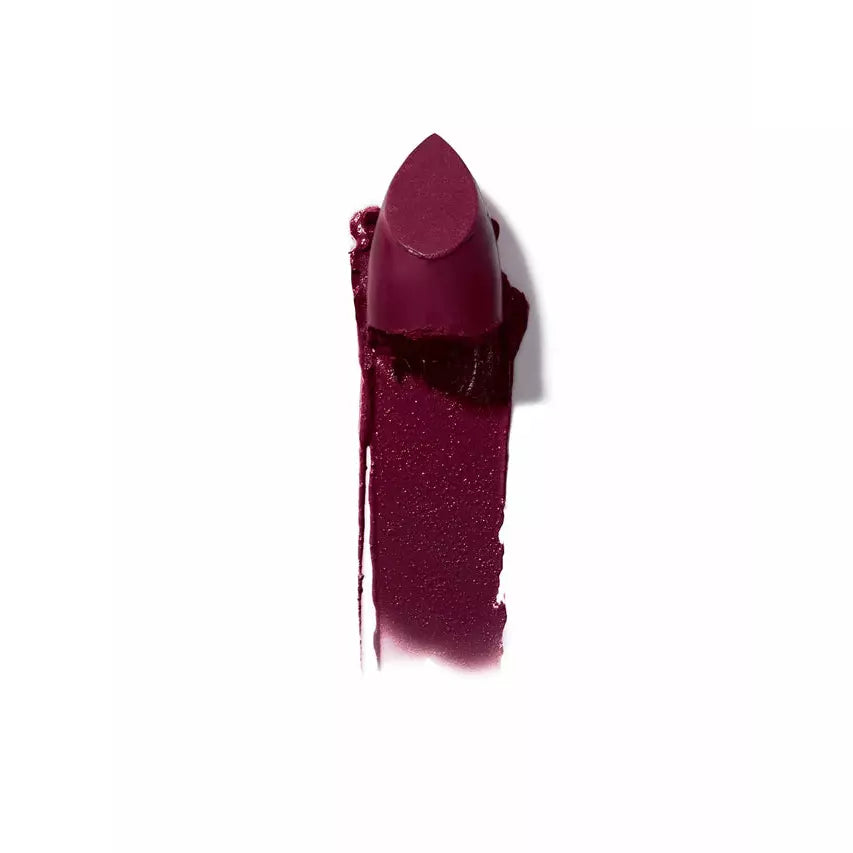 A smudged dark purple lipstick against a white background.