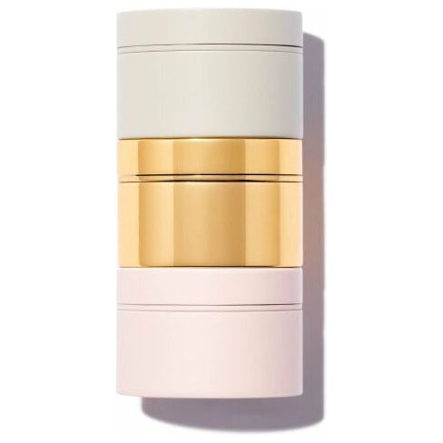 Stacked cylindrical containers in a gradient of neutral to pastel colors with a golden band in the center.