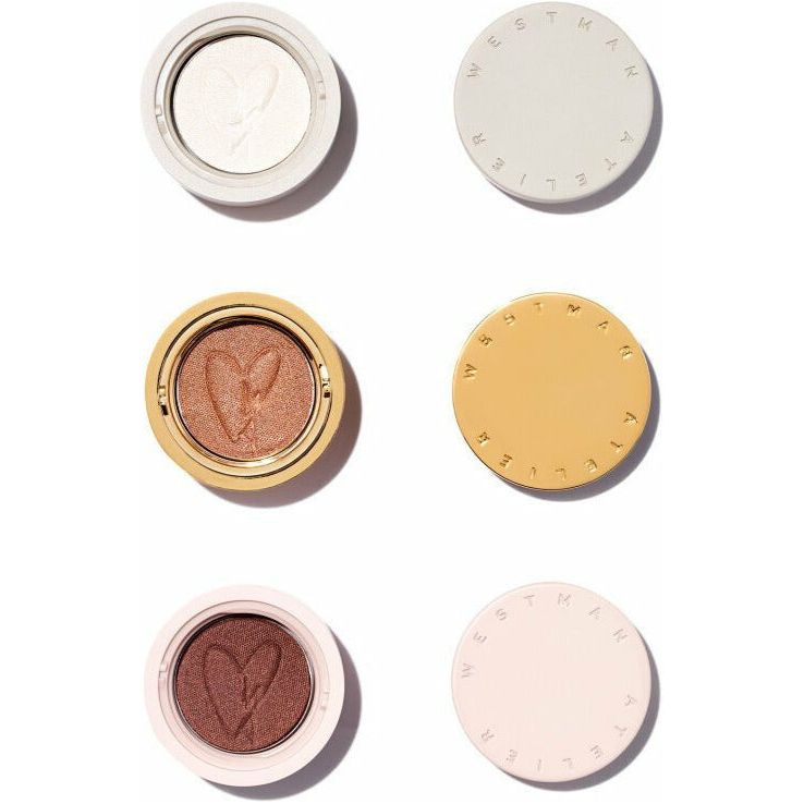 Four compact makeup products with embossed hearts, arranged neatly against a white background.