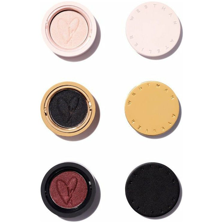 A collection of four circular cosmetic compacts with powders embossed with heart shapes, presented on a white background.