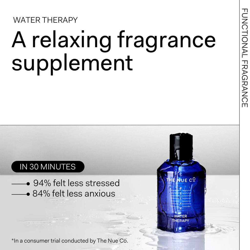 Blue bottle of "water therapy" fragrance supplement on a wet surface with claims of reducing stress.