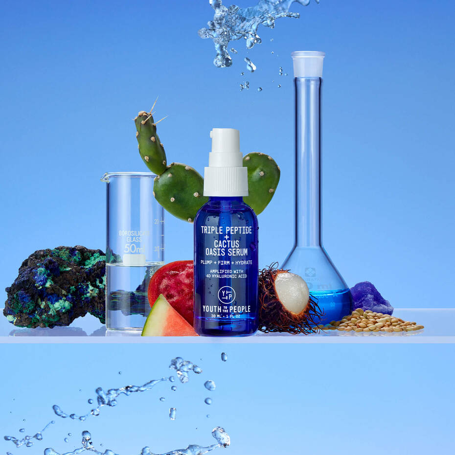 Skincare products with natural ingredients depicted with splashing water, emphasizing hydration and purity.