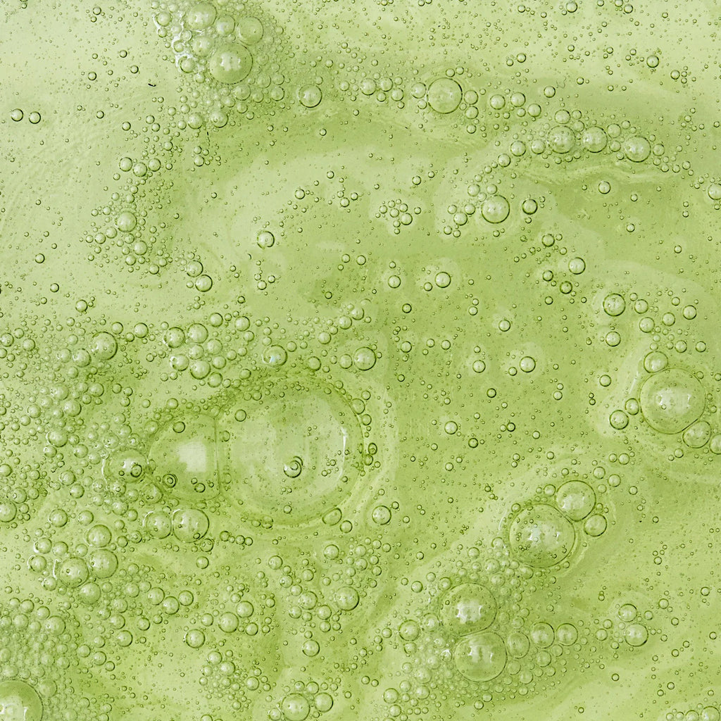 Bubbles formed in a green viscous liquid.