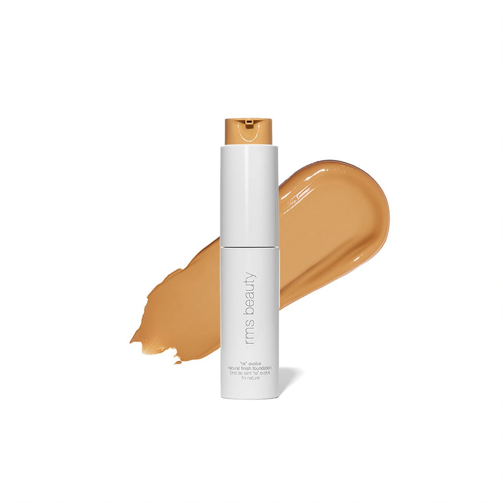 A bottle of liquid foundation makeup with a smear of the product in front of it.