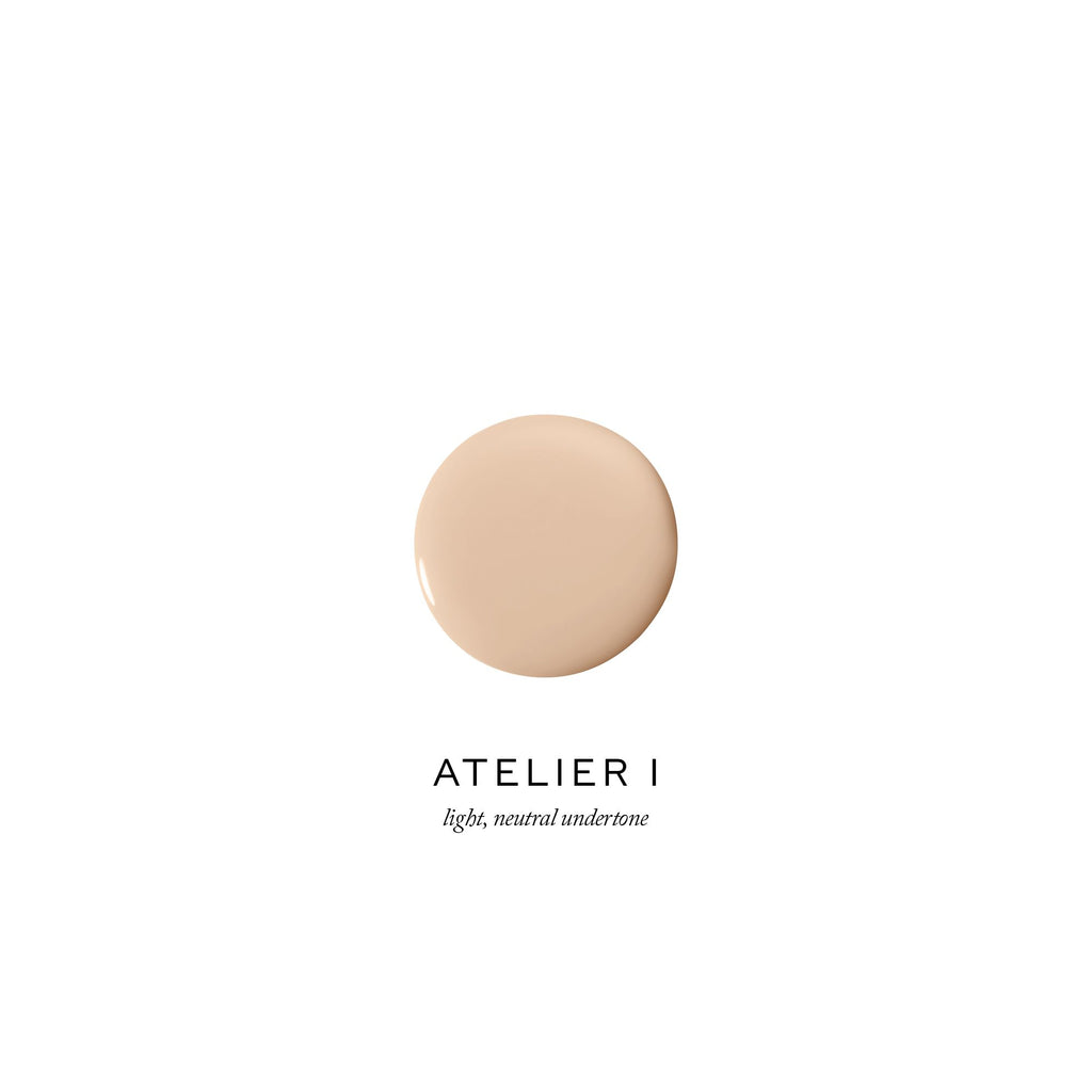 Dollop of foundation makeup with a light, neutral undertone labeled "atelier i".