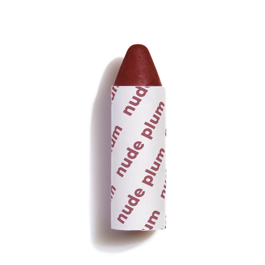 A lipstick with a plum shade partially rolled up against a white background.