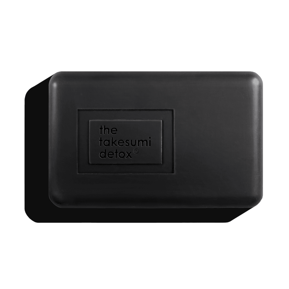 A bar of black detox soap with the label "the takesumi detox".