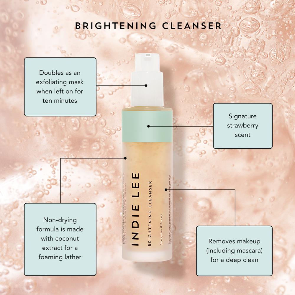 A promotional image of indie lee brightening cleanser highlighting its features: exfoliating properties, strawberry scent, makeup removal ability, and non-drying coconut formula.