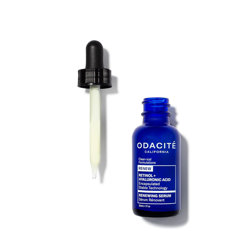 A dropper with liquid beside a blue bottle of odacite skincare serum.