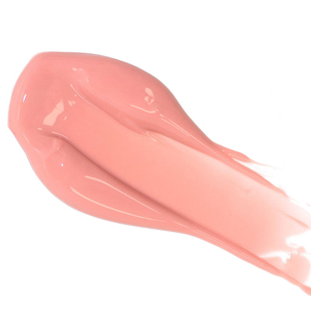 A smear of pink lip gloss on a white background.