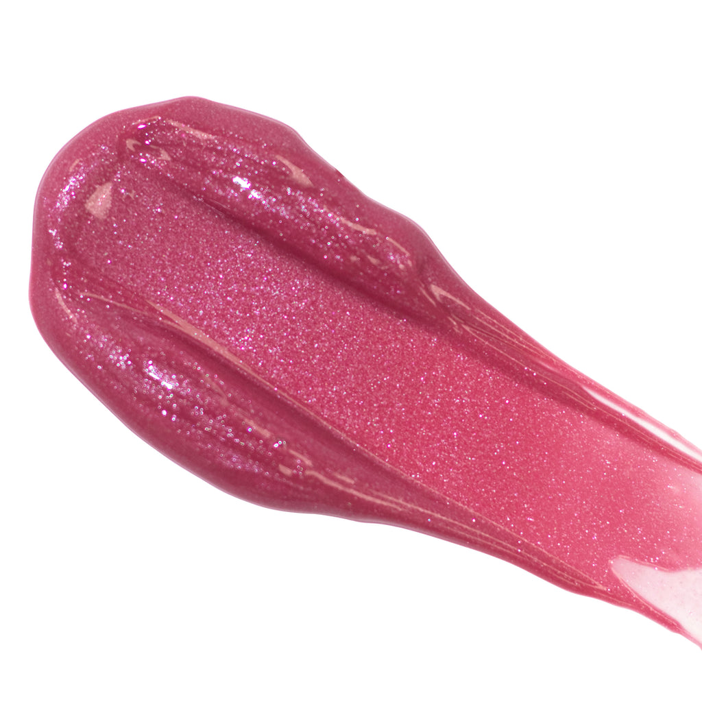 Swatch of shimmering pink lip gloss on a white background.