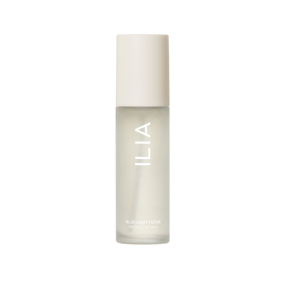 A bottle of ilia blue light filter facial mist isolated on a white background.
