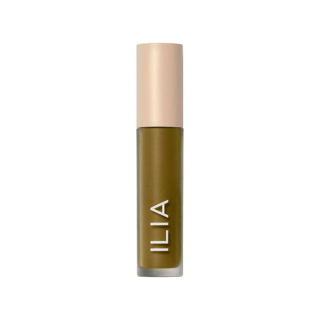 Ilia brand cosmetic product in a cylindrical container with a beige cap.