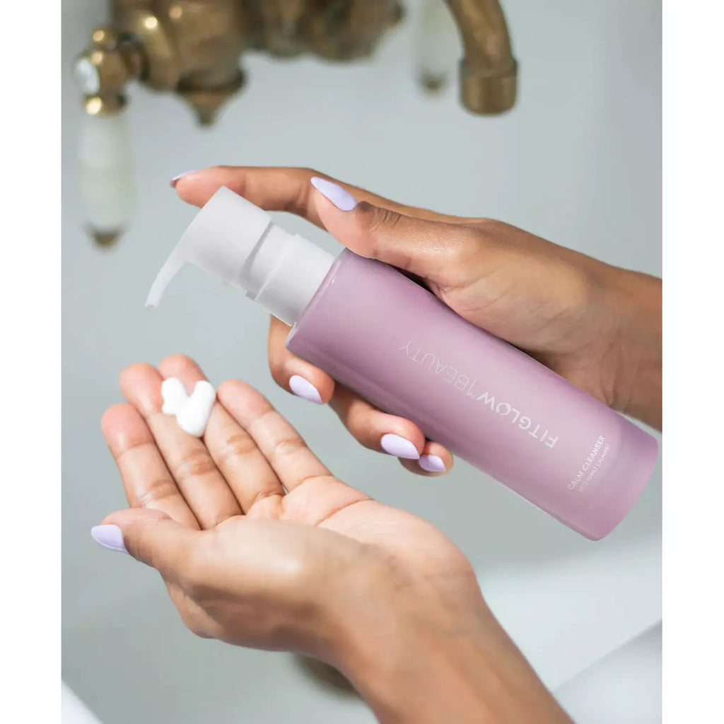 Person dispensing lotion from a bottle into their hand.