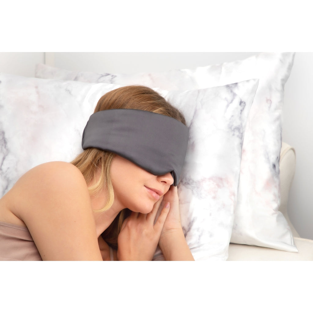 Woman resting with a sleep mask on.