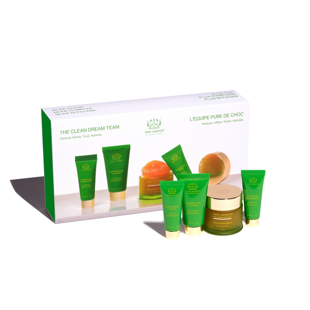A set of skincare products with green packaging displayed in front of their box.