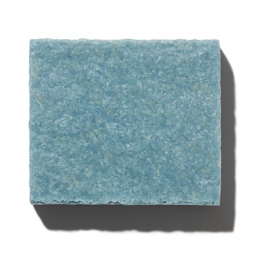 A blue square tile with a textured surface casting a shadow on a white background.