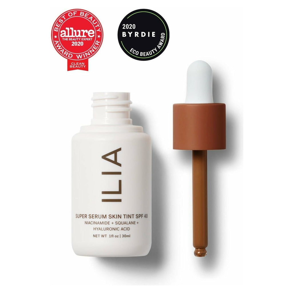 Bottle of ilia super serum skin tint spf 40 and its dropper, displaying awards from allure and byrdie.