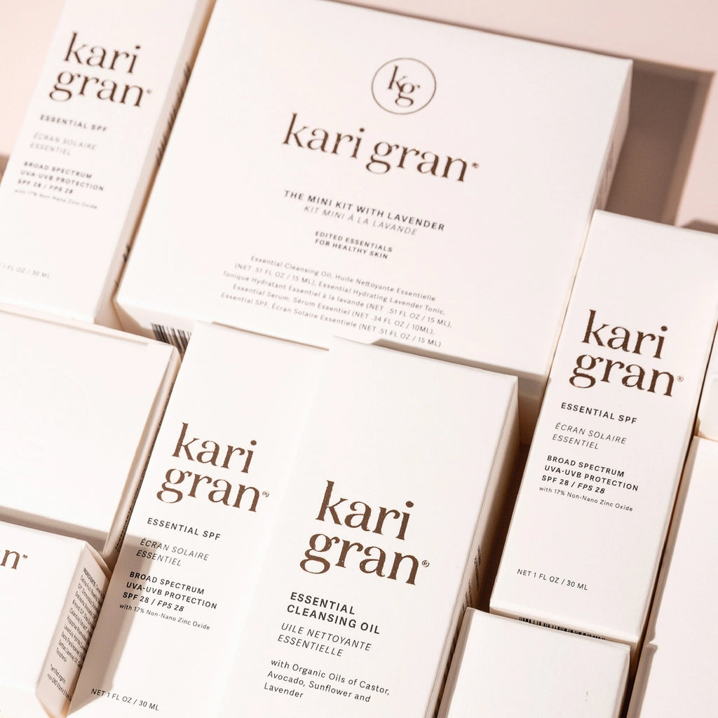 A collection of kari gran skincare products in minimalist packaging.