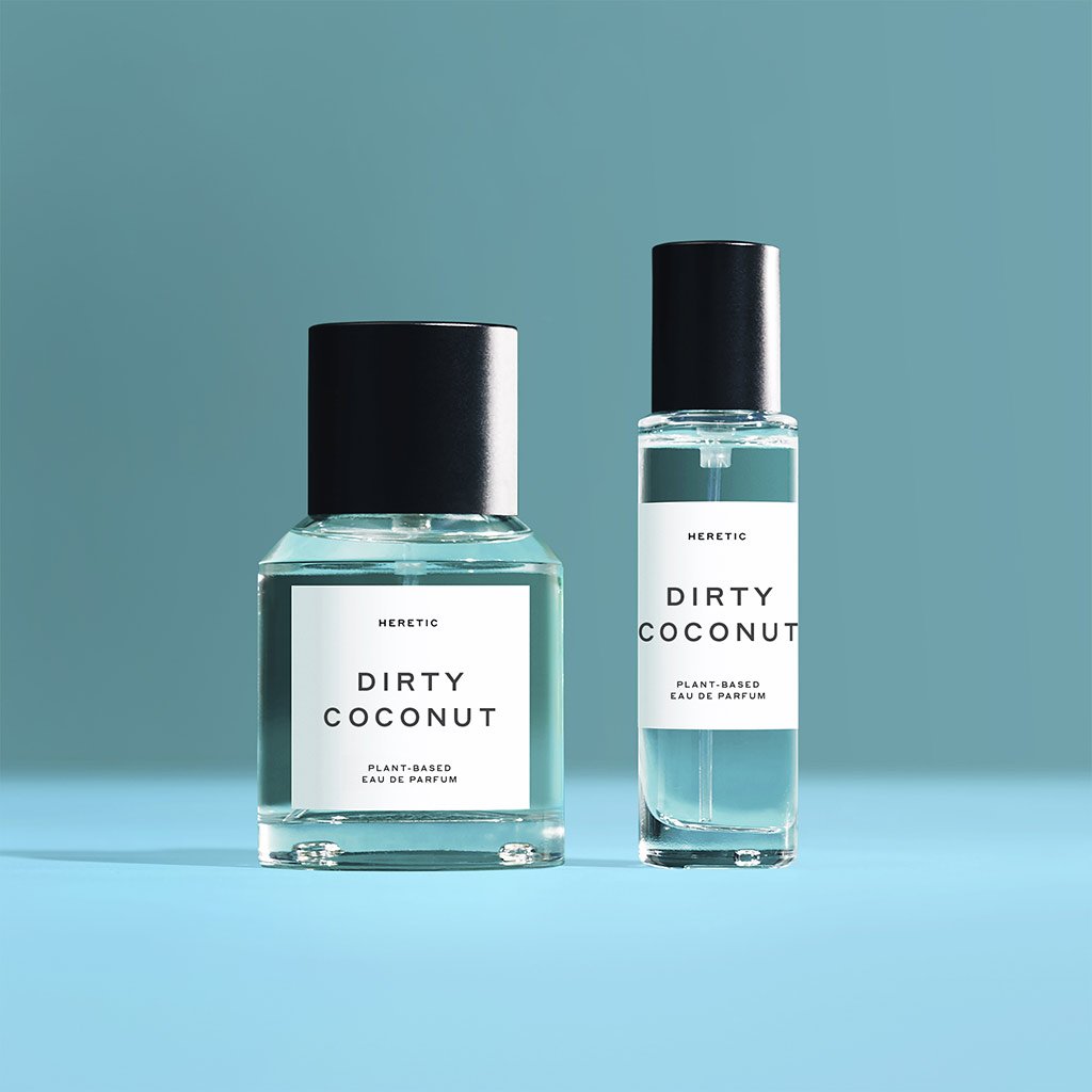 Two bottles of 'dirty coconut' plant-based perfume against a teal background.