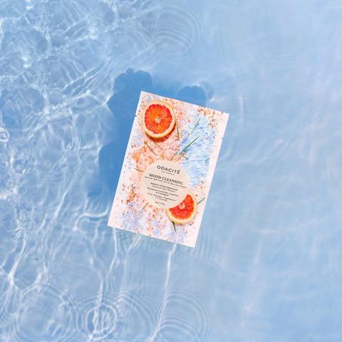 A book floating on clear, rippling water with a citrus-themed cover.