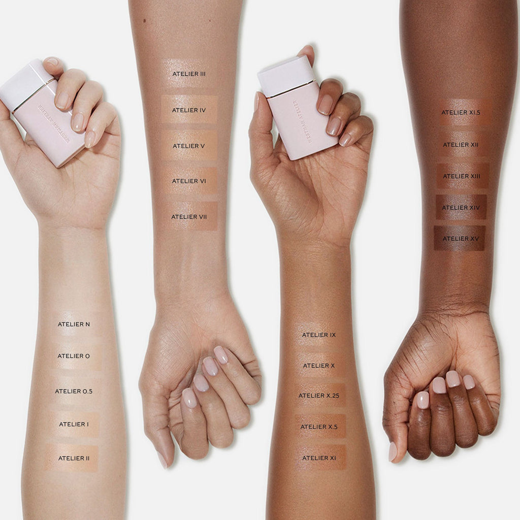 Eight arms of diverse skin tones displaying swatches of different foundation shades with labeled containers.