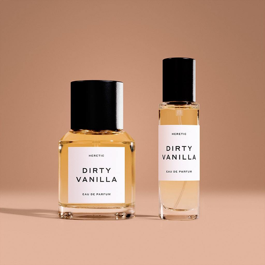 Two bottles of heretic dirty vanilla eau de parfum against a beige background.