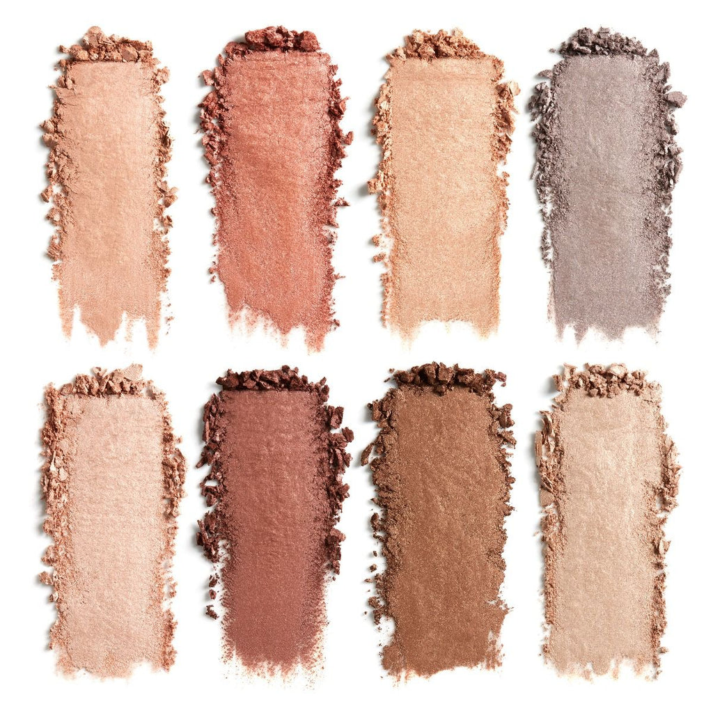 A variety of powdered eyeshadow shades swatched in straight lines on a white background.