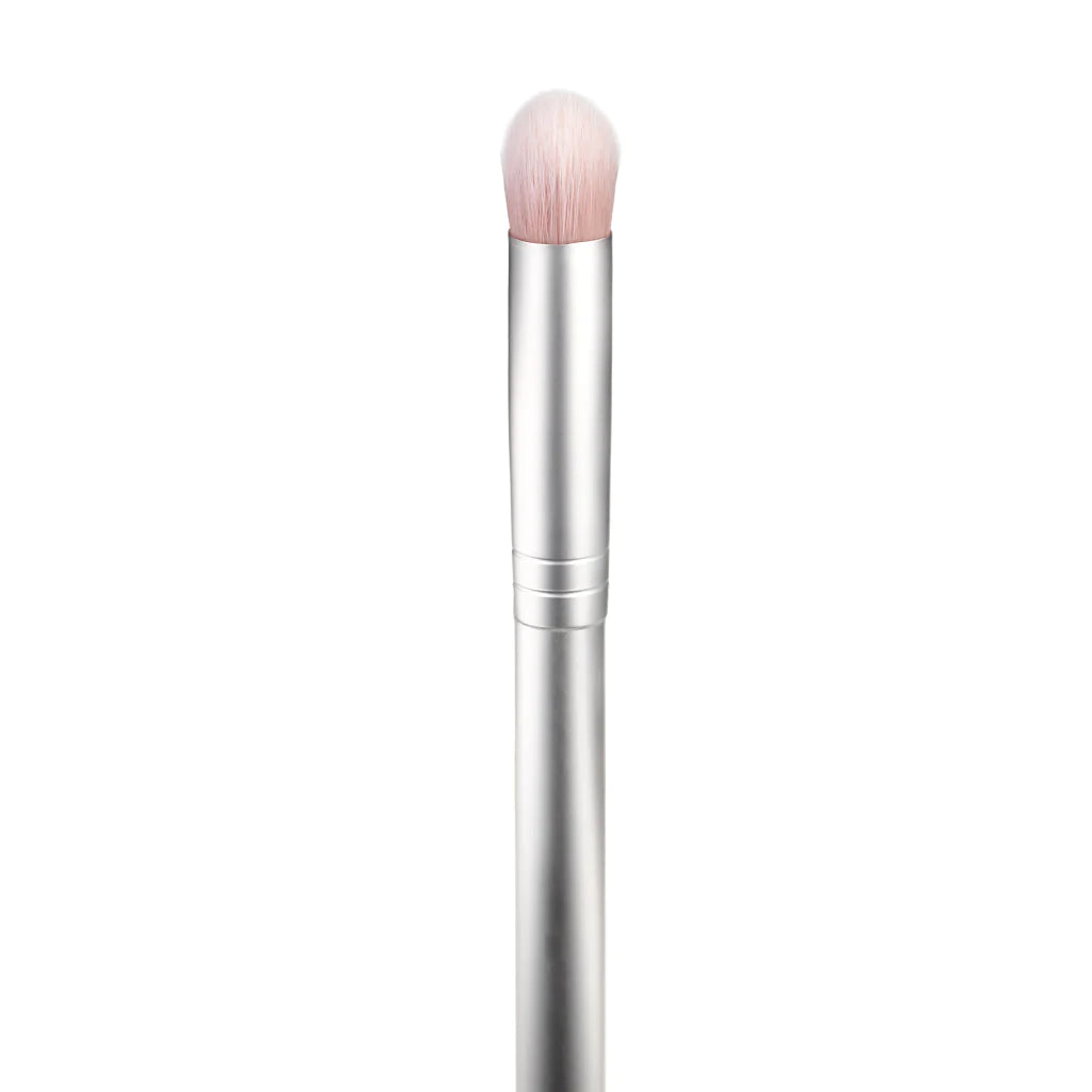 A silver makeup brush with soft bristles against a white background.