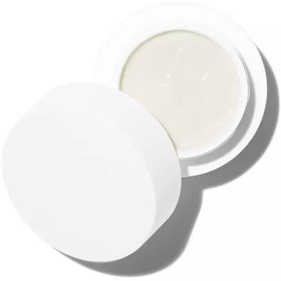 Open jar of cosmetic cream with a white cap beside it on a white background.