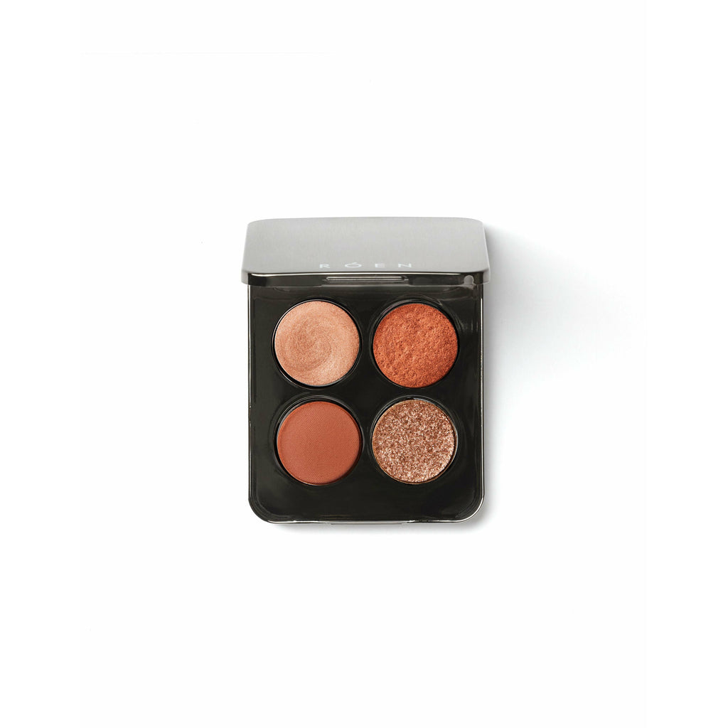 Quadruple eyeshadow palette with a range of brown tones, isolated on white background.