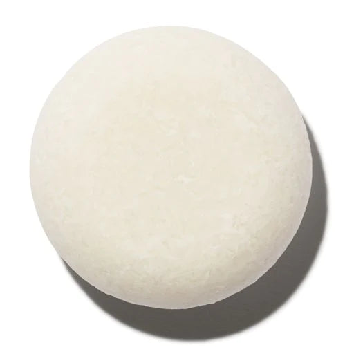 A single white spherical object casting a soft shadow on a light background.