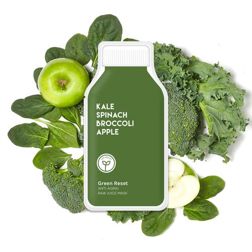 Green juice bottle surrounded by kale, spinach, broccoli, and an apple, indicating its ingredients.