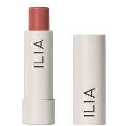 Ilia brand lipstick with cap beside it.