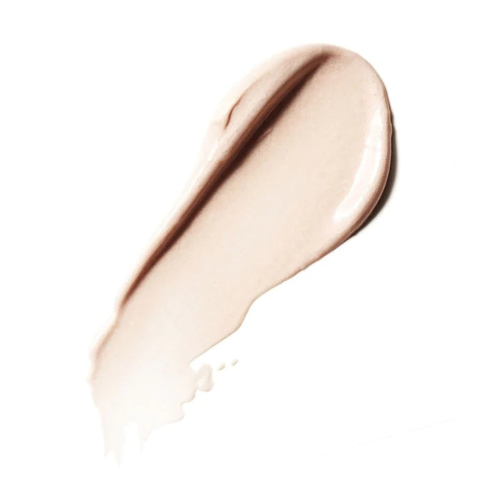 A swatch of liquid foundation makeup smeared on a white background.