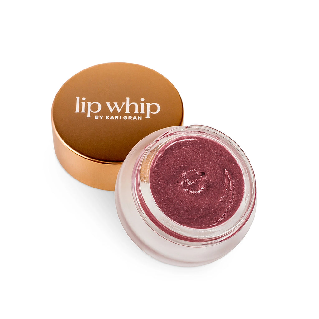 A jar of lip whip lip balm next to its matching lid on a white background.