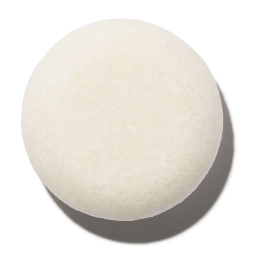 A single white, round object casting a shadow on a light background, resembling a sphere with a textured surface.
