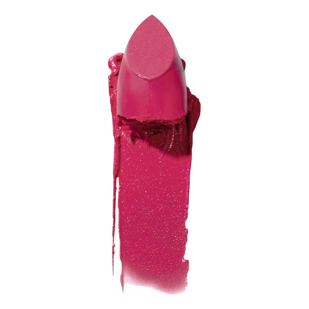 A swatch of vibrant pink lipstick with a creamy texture smeared on a white background.
