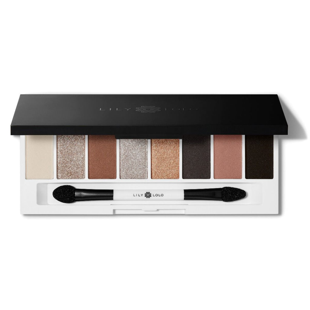 An eyeshadow palette with eight different shades and a dual-ended applicator brush.
