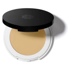 Compact powder foundation with black lid and light beige cosmetic product visible.