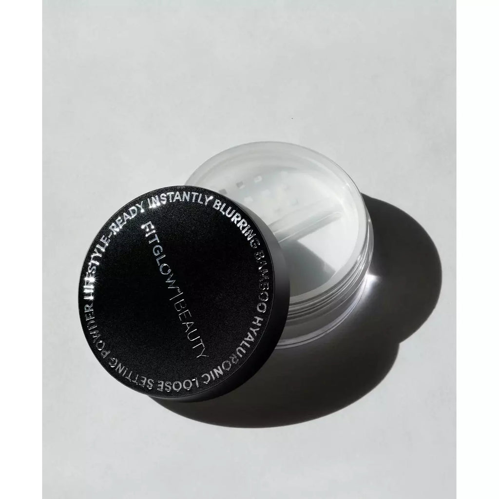 A jar of translucent cosmetic primer with a black lid casting a shadow.